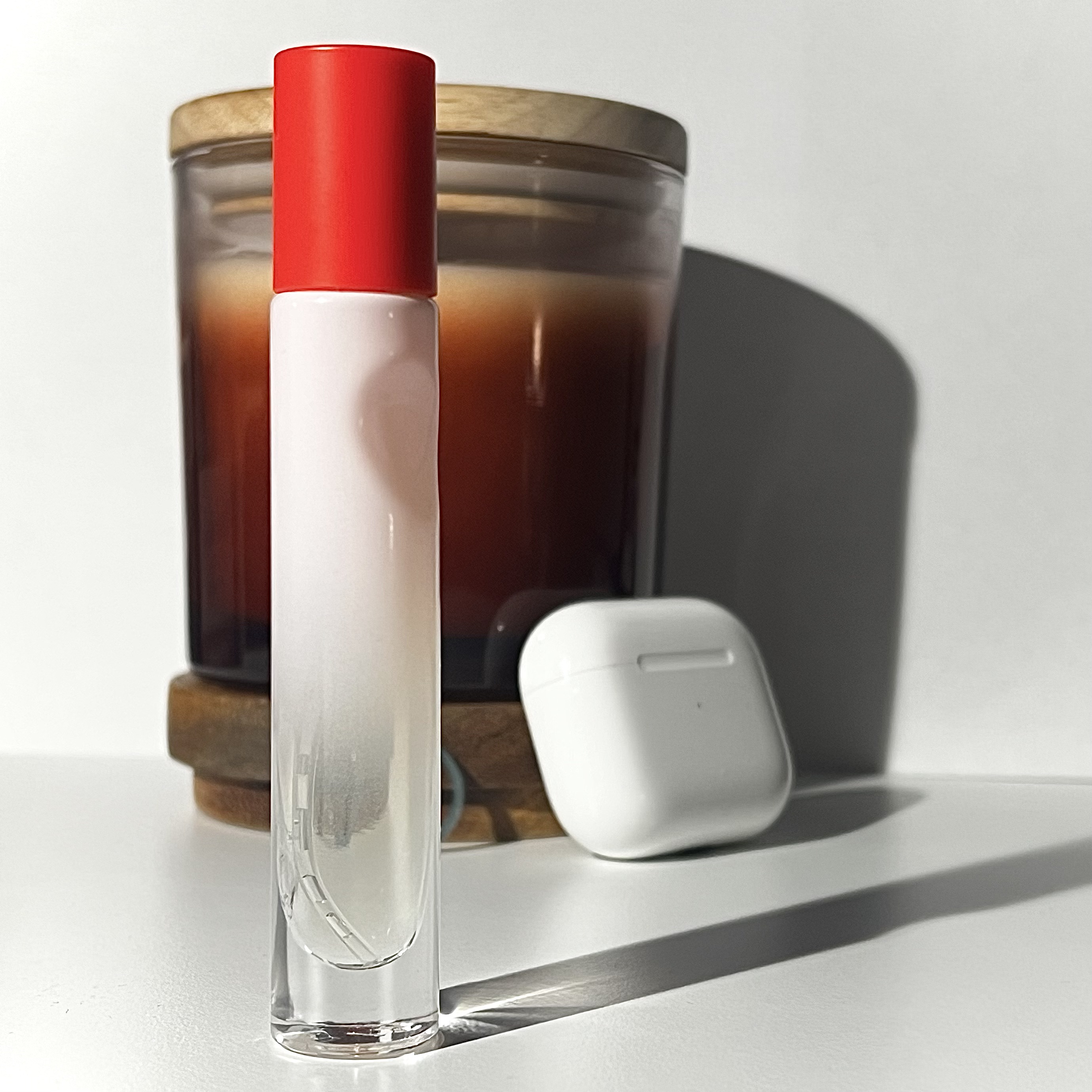 a photo of a mini glossier perfume bottle